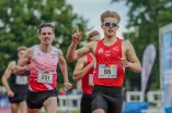 Paul Gröver cheers as he sprints to the finish line over 800 meters.
